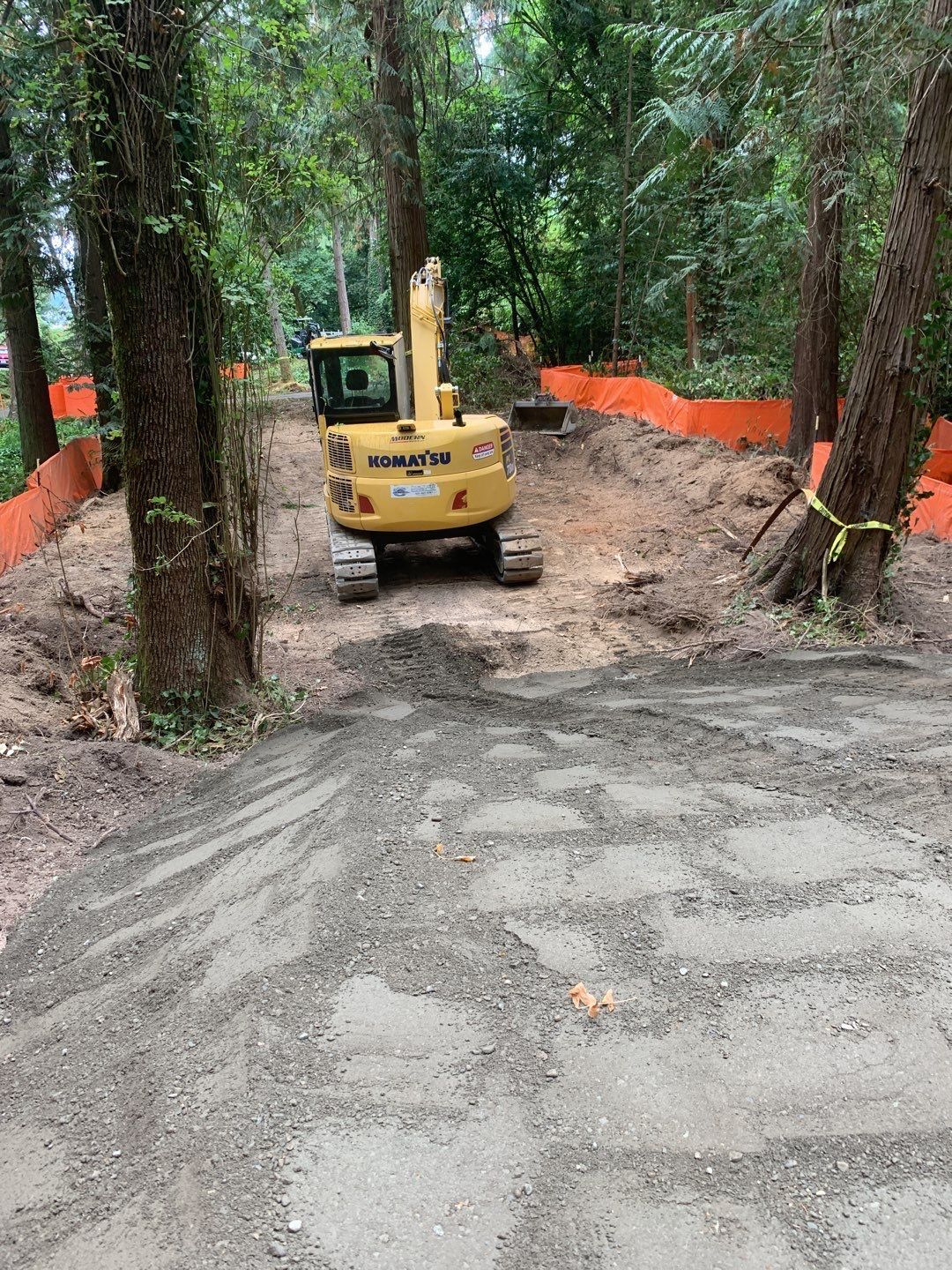 A small excavator in the woods.